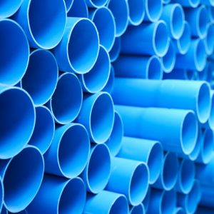 background of colorful  Blue PVC pipes stacked in construction site